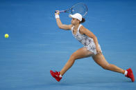 Ash Barty of Australia plays a forehand return to Lesia Tsurenko of Ukraine during their first round match at the Australian Open tennis championships in Melbourne, Australia, Monday, Jan. 17, 2022. (AP Photo/Hamish Blair)