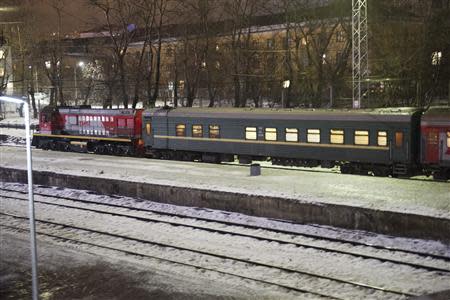 A passenger train starts, with a green carriage which is believed to transport 30 people who were arrested over a Greenpeace protest at the Prirazlomnaya oil rig seen in the train formation, in Murmansk on the way to St. Petersburg, November 11, 2013. REUTERS/Dmitri Sharomov/Greenpeace/Handout via Reuters