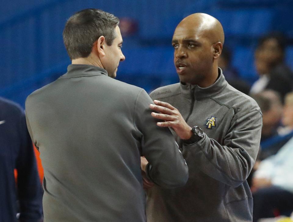 Delaware head coach Martin Ingelsby (left) and North Carolina A&T head coach Monte Ross greet each other in the handshake line after Delaware's 90-71 win at the Bob Carpenter Center, Thursday, Jan. 25, 2024.