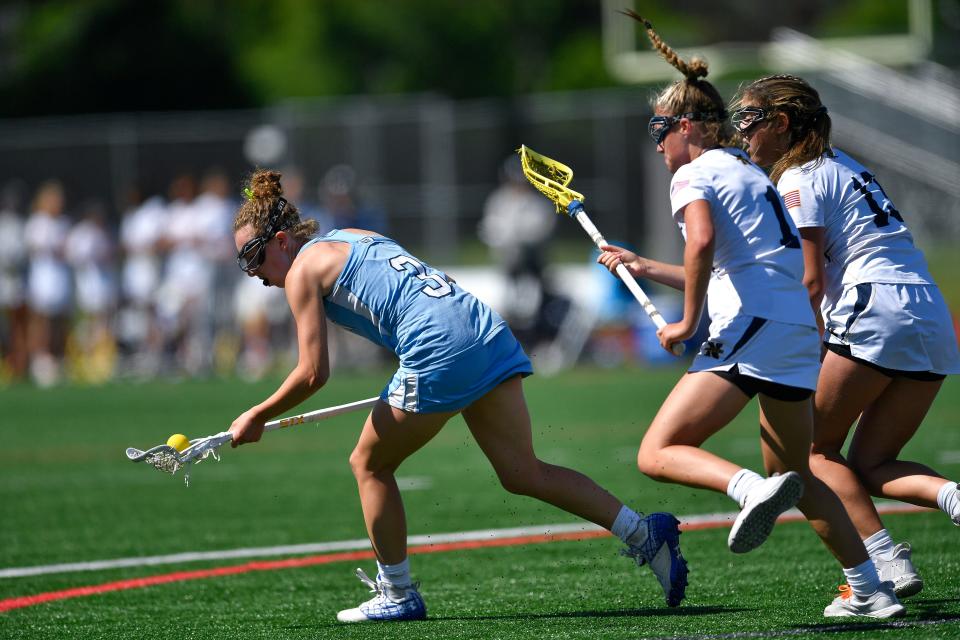 Suffern's Emma Muchnick, left, scoops a loose ball in front of Northport's Emma McLam during a Class A semifinal at the NYSPHSAA Girls Lacrosse Championships in Cortland, N.Y., Friday, June 10, 2022.