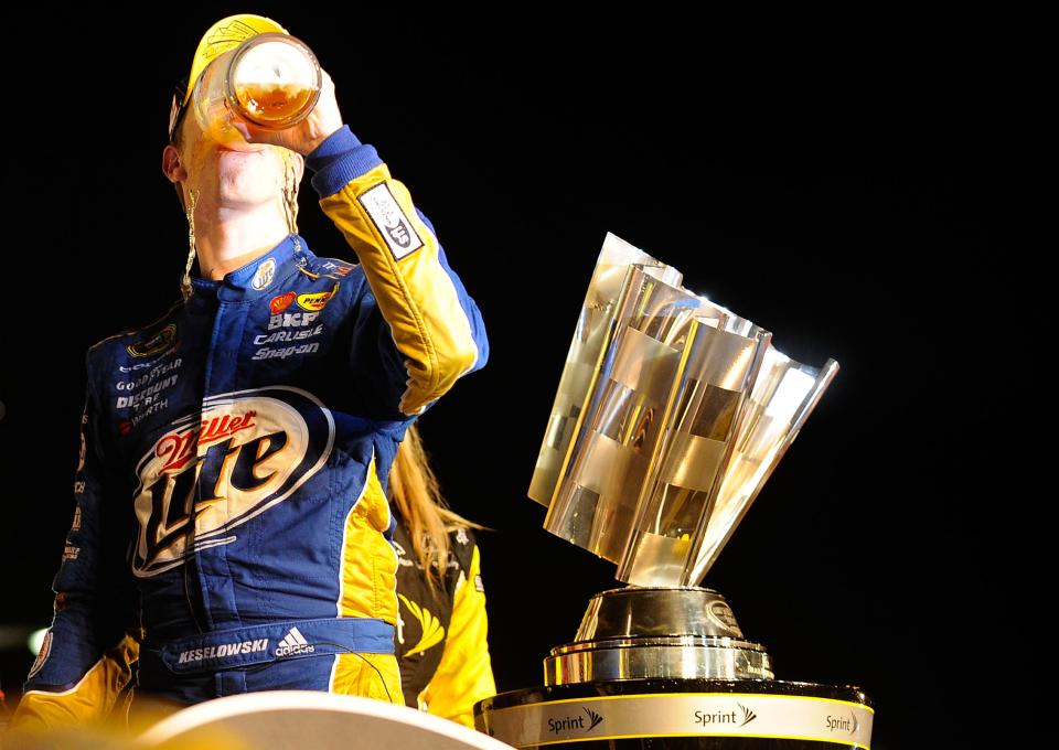 Brad Keselowski, driver of the #2 Miller Lite Dodge, celebrates with a beer in Champions Victory Lane after winning the series championship and finishing in fifteenth place for the NASCAR Sprint Cup Series Ford EcoBoost 400 at Homestead-Miami Speedway on November 18, 2012 in Homestead, Florida. (Photo by Jared C. Tilton/Getty Images for NASCAR)