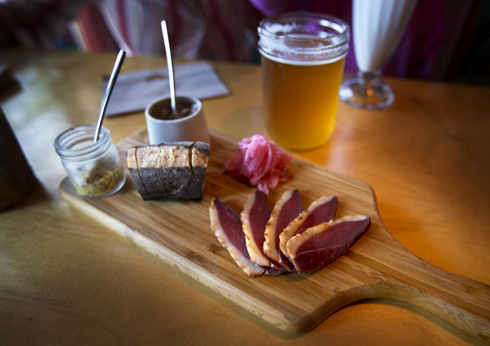 This photo made Friday, July 12, 2013, shows a charcuterie board served with duck, warm baguette and handcrafted condiments, at Duckfat, a small sandwich shop in Portland, Maine. (AP Photo/Robert F. Bukaty)