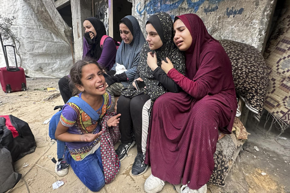 Palestinian survivors react in front of the rubble of their family building, following Israeli airstrike in Nusseirat refugee camp in Gaza Strip, Tuesday, Oct. 31, 2023. (AP Photo/Doaa AlBaz)