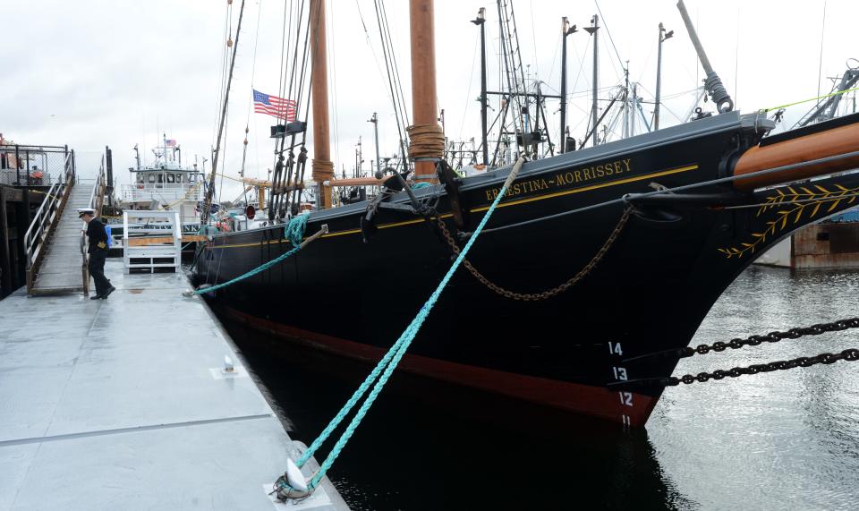 Capt. Tiffany Krihwan, left, heads up the gangway beside the tall ship Ernestina-Morrissey during a homecoming celebration for the tall ship at the State Pier in New Bedford on Saturday.