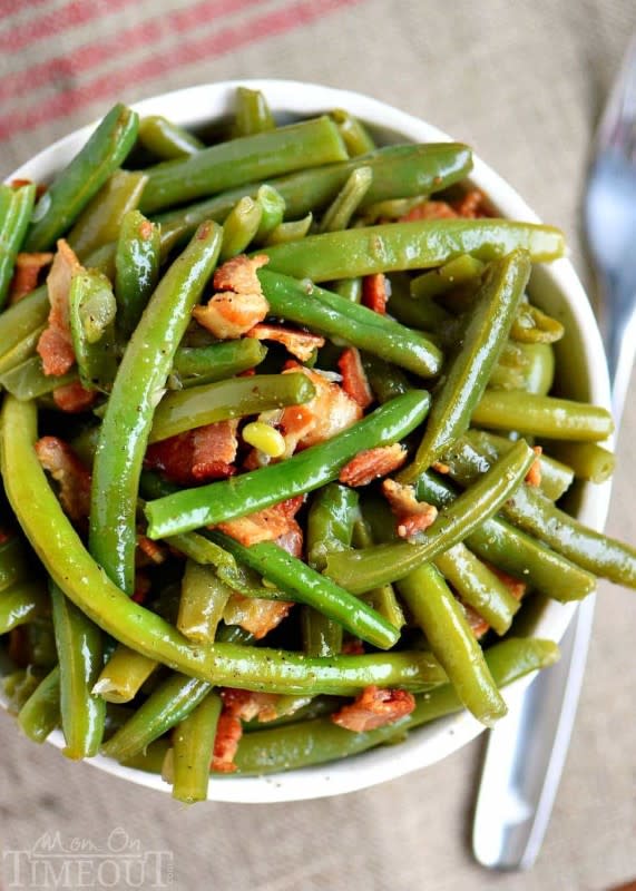 <p>Mom on Timeout</p><p>Cooking these beans with bacon and onions for as long as possible makes them tender and super flavorful. Get this <a href="https://www.momontimeout.com/nanas-famous-green-beans/" rel="nofollow noopener" target="_blank" data-ylk="slk:Nana’s Famous Green Beans;elm:context_link;itc:0;sec:content-canvas" class="link rapid-noclick-resp">Nana’s Famous Green Beans</a> recipe!</p>