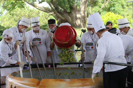 Volunteers from a culinary school mix mashed avocados as they attempt to set a new Guinness World Record for the largest serving of guacamole in Concepcion de Buenos Aires, Jalisco, Mexico September 3, 2017. REUTERS/Fernando Carranza