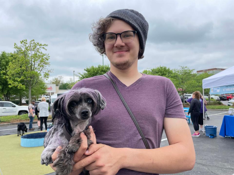 Raymond Newman brought his dog, Sprite, (complete with purple fur) to enjoy the day at Puppy Palooza at the Pinnacle at Turkey Creek on April 15, 2023.