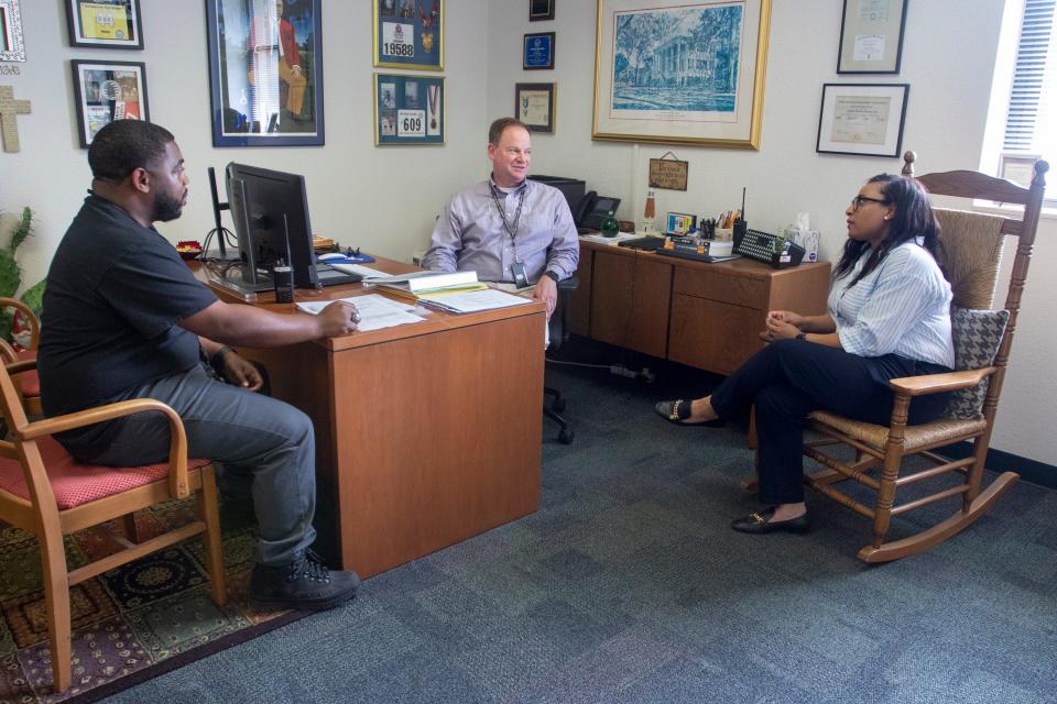 From left, Assistant Principal Travis Griffin, Principal Denny Wilson and Assistant Principal Adrienne Green talk May 24 in the offices at Warrington Middle School.