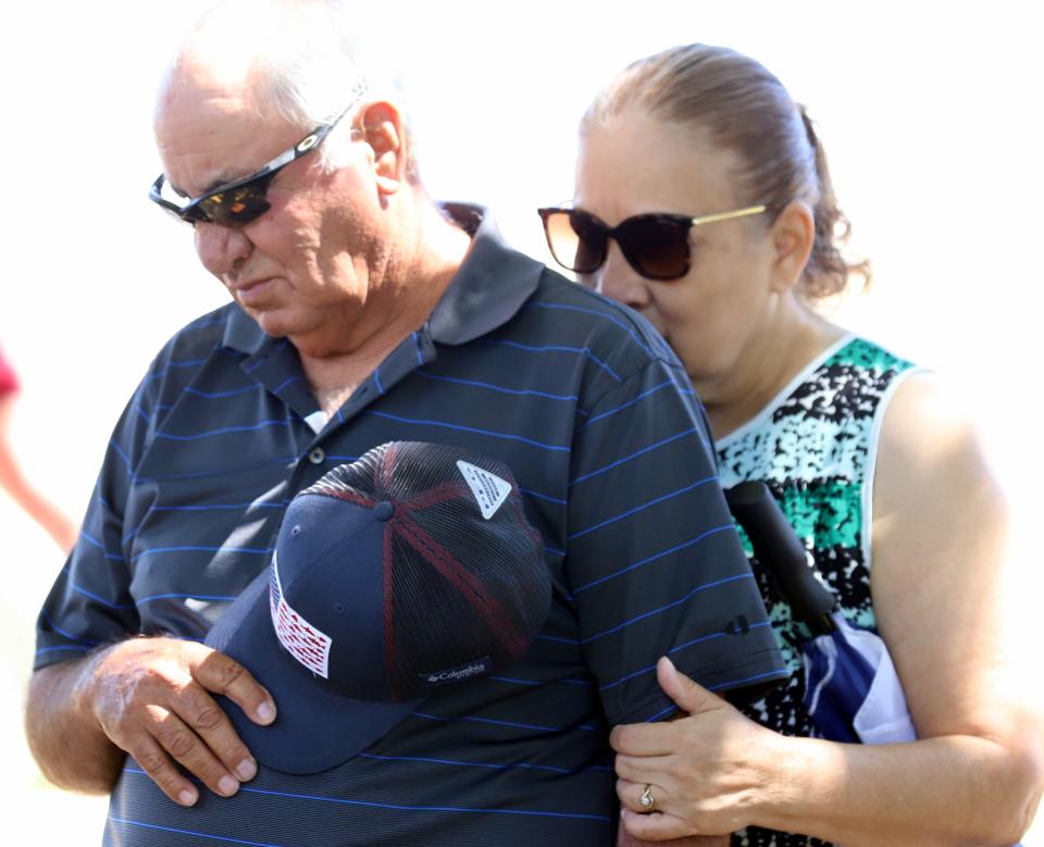 Jimmy and Rose Galindo share a solemn embrace during Monday's Memorial Day ceremony.