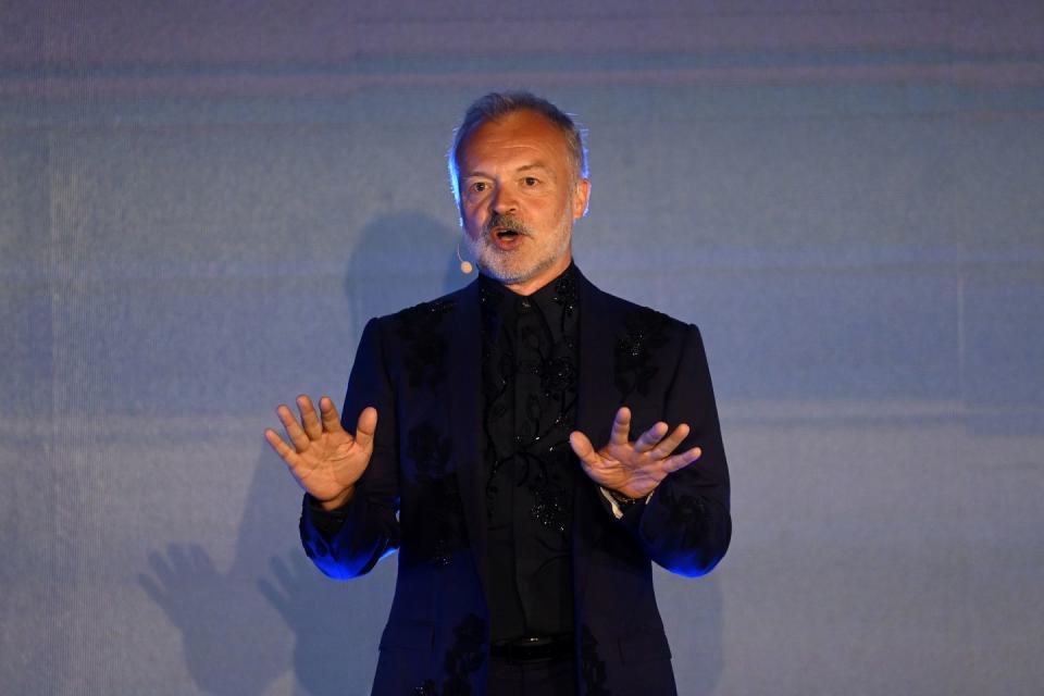 graham norton wears a black suit on stage at paramount plus uk launch