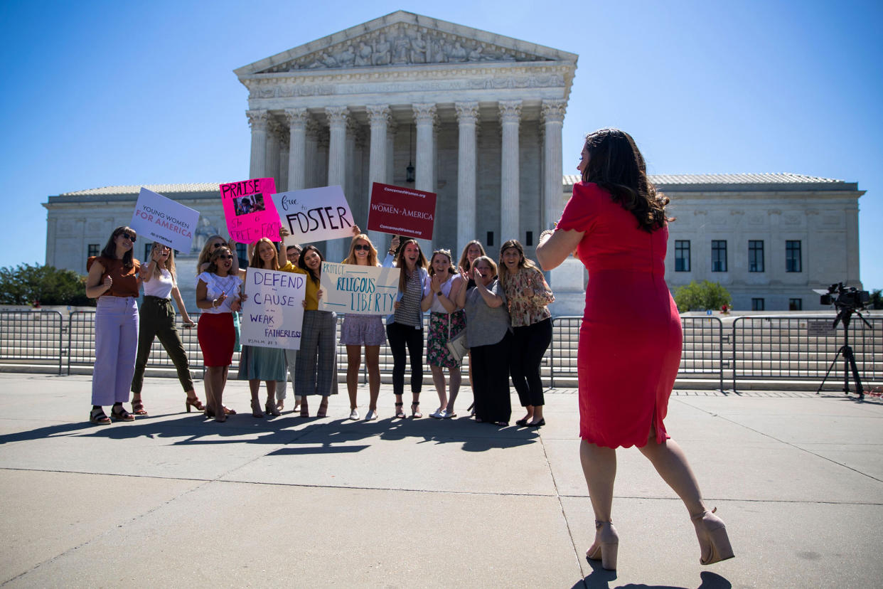 People stand in front of the Supreme Court in Washington, DC, USA, 17 June 2021. The Supreme Court dismissed a challenge to the Affordable Care Act and delivered a unanimous defeat to LGBT couples in a case over whether the city of Philadelphia could refuse to work with a Roman Catholic adoption agency whose religious beliefs prevent it from working with same sex foster parents. The Supreme Court issues opinions, Washington, USA - 17 Jun 2021.