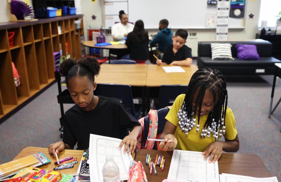 Fifth graders Parris Vallian, 10, left, and Journi Ceasar, 10, fill out a worksheet during the first day of school at Townley Elementary on Wednesday, August 10, 2022, in Everman.