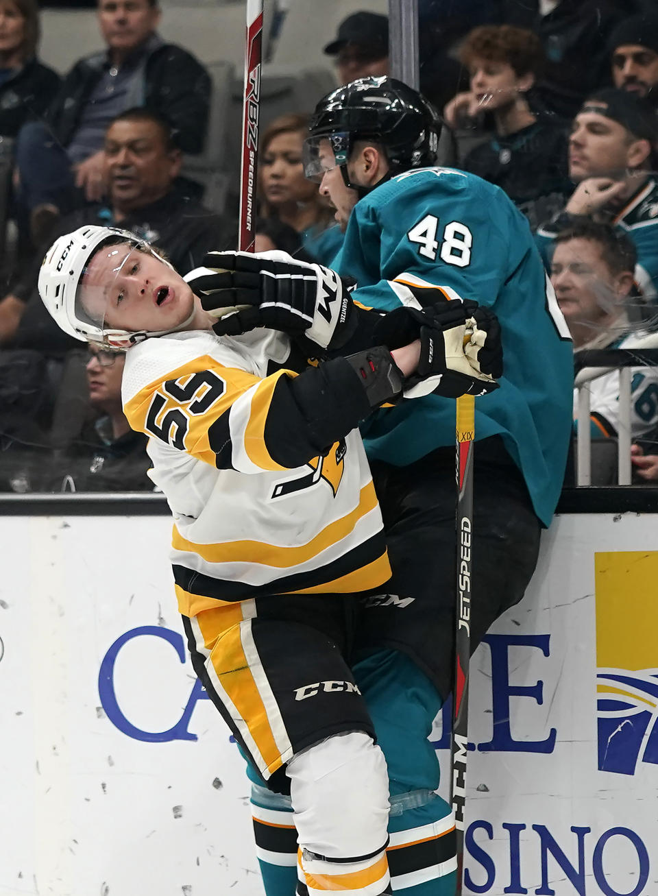 San Jose Sharks center Tomas Hertl (48) is checked into the boards by Pittsburgh Penguins left wing Jake Guentzel (59) during the first period of an NHL hockey game in San Jose, Calif., Tuesday, Jan. 15, 2019. (AP Photo/Tony Avelar)