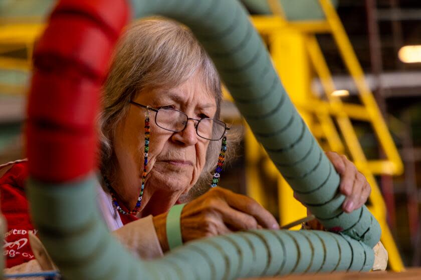 IRWINDALE, CA - DECEMBER 26: Victoria Boyd, 79, for last 36 years, flys out every year Christmas night from a small town in Southern Illinois to join friends in decorating floats for the annual Rose Parade. Boyd works on float at Fiesta Parade Floats on Tuesday, Dec. 26, 2023 in Irwindale, CA. (Irfan Khan / Los Angeles Times)