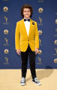 <p>The young <em>Stranger Things</em> actor paired a mustard velvet suit jacket with a pair of black Converse sneakers. (Photo: Getty Images) </p>