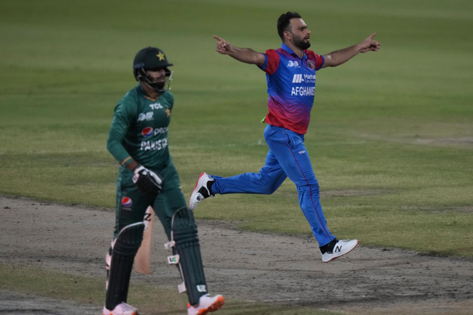 Afghanistan's Fareed Ahmad, right, celebrates the dismissal of Pakistan's Haris Rauf, left, during the T20 cricket match of Asia Cup between Pakistan and Afghanistan, in Sharjah, United Arab Emirates, Wednesday, Sept. 7, 2022. (AP Photo/Anjum Naveed)