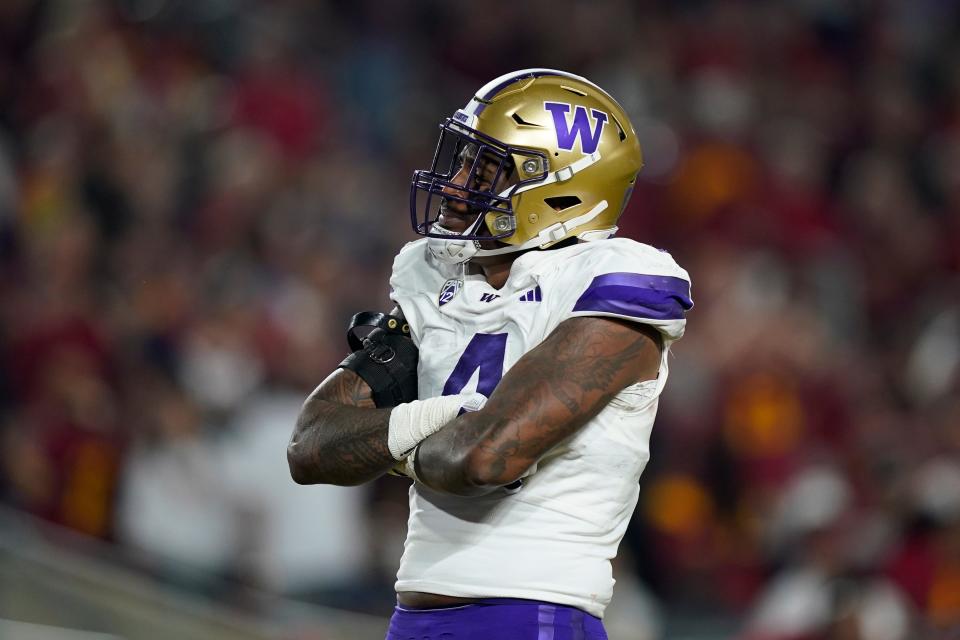 Washington defensive end Zion Tupuola-Fetui reacts after forcing a fumble by Southern California quarterback Caleb Williams during the first half of an NCAA college football game Saturday, Nov. 4, 2023, in Los Angeles.
