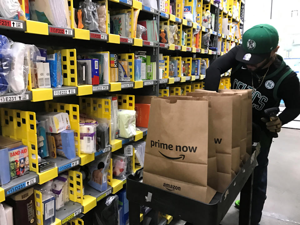 An employee collects items ordered by Amazon.com customers through the company's two-hour delivery service Prime Now in a warehouse in San Francisco, California, U.S., December 20, 2017.   REUTERS/Jeffrey Dastin