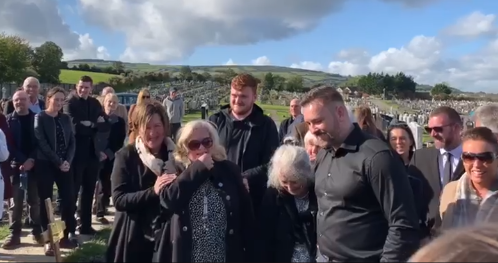 Bradley’s family laugh as they hear him prank them for one last time, from beyond the grave. — Screen capture via Facebook/Andrea Bradley