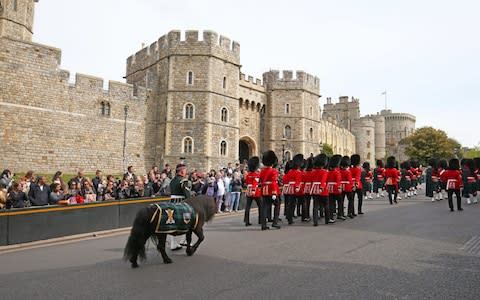 Crowds watch the changing of the guard at Windsor Castle  - Credit: Jonathan Brady/PA