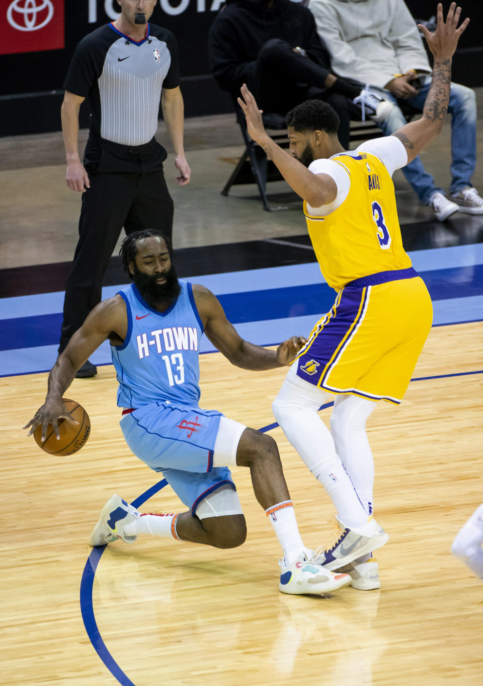 Houston Rockets guard James Harden (13) falls as he tries to drive on Los Angeles Lakers forward Anthony Davis (3) during the first quarter of an NBA basketball game Tuesday, Jan. 12, 2021, in Houston. (Mark Mulligan/Houston Chronicle via AP)