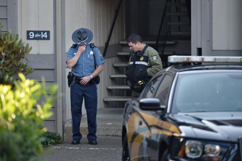 Police officers stand guard outside the apartment building where the alleged gunman, Chris Harper Mercer, lived in Roseburg, Oregon, on October 2, 2015. The rampage on October 1 at Umpqua Community College left 10 dead and shattered a close-knit rural community in the south of the state.&nbsp;