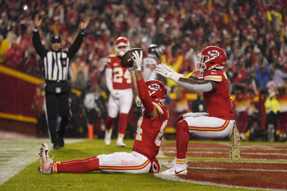 Kansas City Chiefs wide receiver Justin Watson is congratulated by teammate Jerick McKinnon, right, after scoring during the first half of an NFL football game against the Philadelphia Eagles, Monday, Nov. 20, 2023, in Kansas City, Mo. (AP Photo/Charlie Riedel)