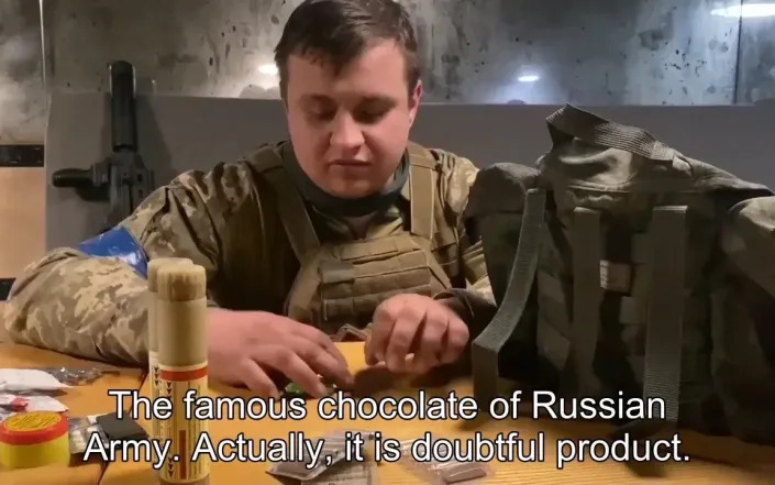 A Ukranian soldier reviews Russian rations