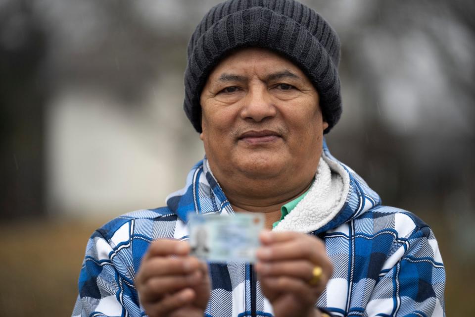 Chhabi Bhujel, a Bhutanese Nepali refugee who lives on Columbus’ Northeast Side, stands for a portrait outside of North YMCA in January while holding his driver’s license. As a noncitizen, Bhujel said he is worried he will face discrimination once he gets a new ID, which will contain the "noncitizen" designation.