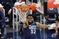 Minnesota Timberwolves' Karl-Anthony Towns dunks during the first half of the team's NBA basketball game against the Charlotte Hornets, Wednesday, March 3, 2021, in Minneapolis. (AP Photo/Jim Mone)