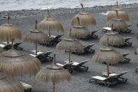 View of empty sun beds at La Caleta beach, near the H10 Costa Adeje Palace hotel in La Caleta, in the Canary island of Tenerife, Spain, Thursday, Feb. 27, 2020. Spanish officials say a tourist hotel on the Canary Island of Tenerife has been placed in quarantine after an Italian doctor staying there tested positive for the COVID-19 virus. (AP Photo/Joan Mateu)