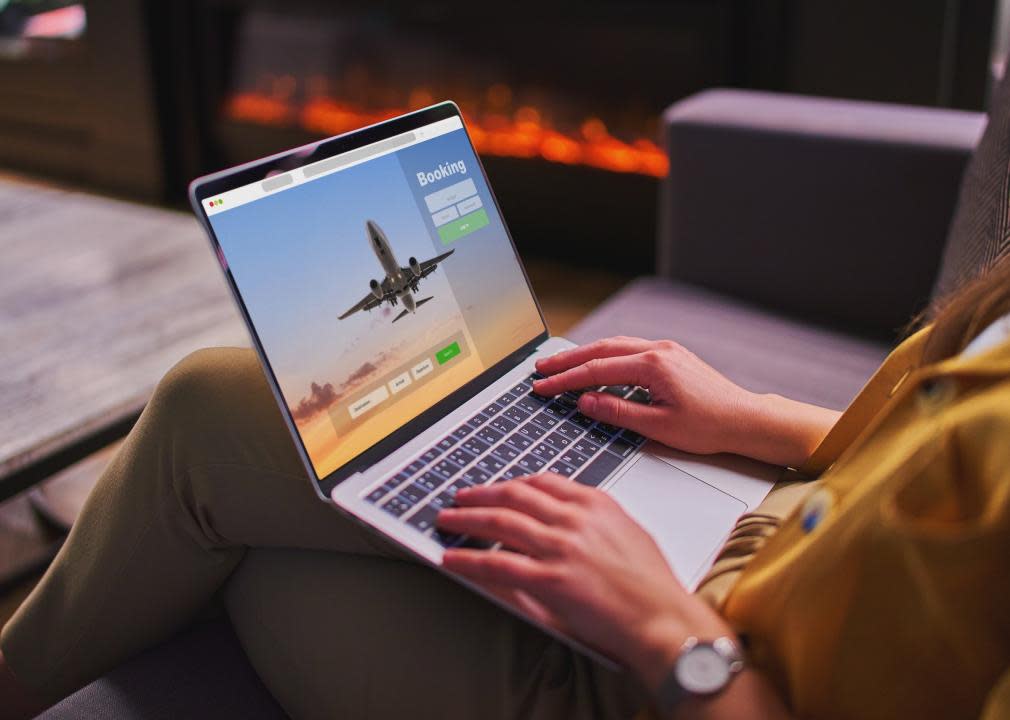 A woman booking plane tickets using a computer.