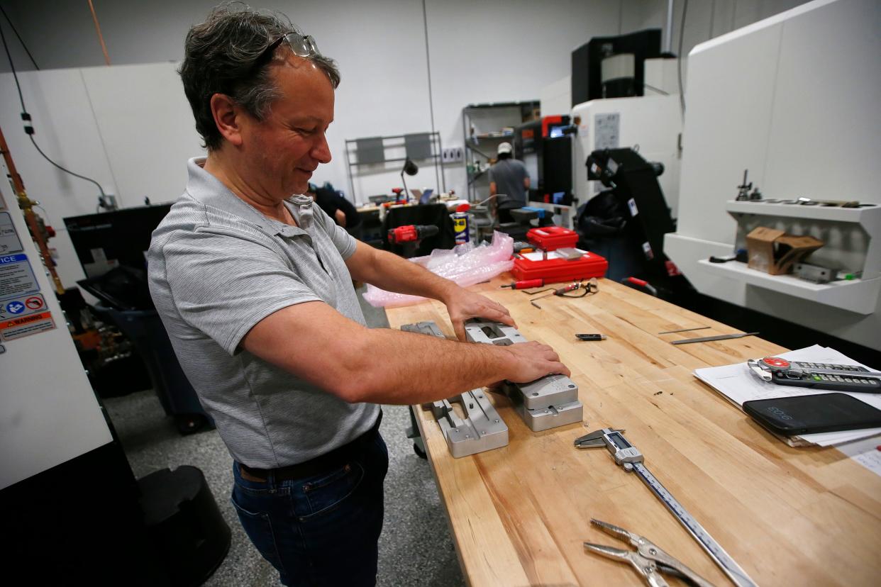 Mike Fernandes, CEO, assembles a newly made part at the new Proto XYZ manufacturing facilty on Potomska Street in New Bedford.