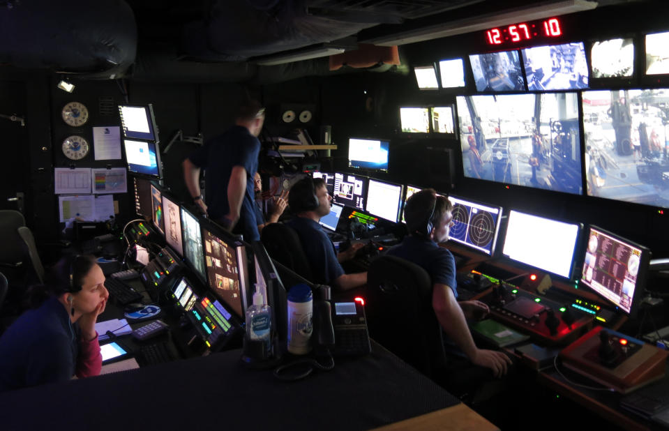 Scientists prepare to analyze data aboard the Okeanos Explorer ship of the U.S. National Oceanic and Atmospheric Administration in San Juan, Puerto Rico, Monday, Oct. 29, 2018. Scientists will analyze coral and fish habitats as well as map geological features, exploring new sites in deep waters around Puerto Rico and the U.S. Virgin Islands as part of the 22-day mission. (AP Photo/Danica Coto)