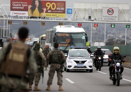 Police officers are seen on the Rio-Niteroi Bridge, where security forces shot dead a man who hijacked a commuter bus in Rio de Janeiro