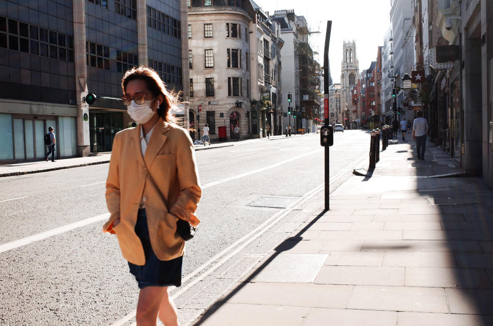 A woman wearing a face mask walks along a near-deserted Fleet Street in London, England, on May 29, 2020. The UK is now in its tenth week of coronavirus lockdown, with total deaths after a positive covid-19 test now standing at 38,161, according to today's updated count from the Department of Health and Social Care. In England, a raft of eased restrictions are due to go into effect from Monday, including permission for groups of up to six people to meet outdoors. English primary schools are also due to resume for some year groups from next week, in a move that has been met with significant pushback from teachers' unions and parents. (Photo by David Cliff/NurPhoto via Getty Images)