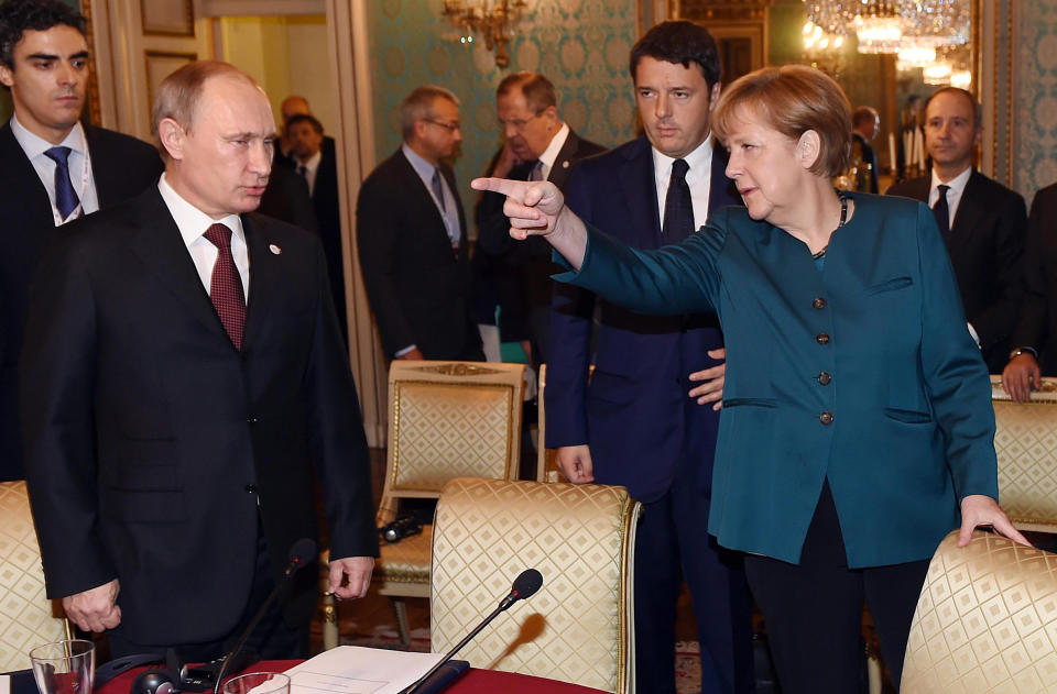 German Chancellor Angela Merkel, right, Russian President Vladimir Putin, left, and Italian Prime Minister Matteo Renzi arrive for a meeting on the sidelines of the ASEM summit of European and Asian leaders in Milan, northern Italy, Friday, Oct. 17, 2014. Russian President Vladimir Putin is looking to get relief from Western economic sanctions imposed since Russia's annexation of the Crimean Peninsula and its support for a pro-Russia insurgency in eastern Ukraine. To that end, he has scheduled a series of meetings on the sidelines of a two-day ASEM summit of European and Asian leaders. (AP Photo/Daniel Dal Zennaro, POOL)