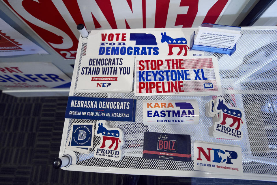 In this June 22, 2020, photo, various campaign stickers are available at the Lancaster County Democratic Party offices in Lincoln, Neb. Even as Democrats are seeing registration gains in other states, the party is falling further behind Republicans in Nebraska. (AP Photo/Nati Harnik)
