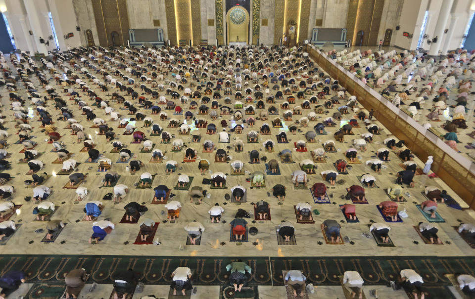 Indonesian Muslims pray spaced apart to help curb the spread of coronavirus outbreak during an Eid al-Fitr prayer marking the end of Ramadan at Al Akbar mosque in Surabaya, East Java, Indonesia, Thursday, May 13, 2021. Muslims celebrated the holiday in a subdued mood for a second year Thursday as the COVID-19 pandemic again forced mosque closings and family separations on the holiday marking the end of Islam's holiest month of Ramadan. (AP Photo/Trisnadi)