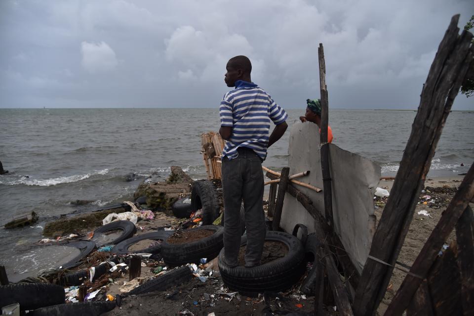 <p>Jean looks at the sea from a house where he is working in the neighborhood of Aviation in Cap-Haitien, Haiti, on Sept. 7, 2017. (Photo: Hector Retamal/AFP/Getty Images) </p>