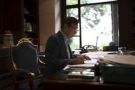 In this Aug. 20, 2019, photo, Huawei's founder Ren Zhengfei reads documents in his office at the Huawei campus in Shenzhen in Southern China's Guangdong province. Ren says its troubles with President Donald Trump are hardly the biggest crisis he has faced while working his way from rural poverty to the helm of China’s first global tech brand. (AP Photo/Ng Han Guan)