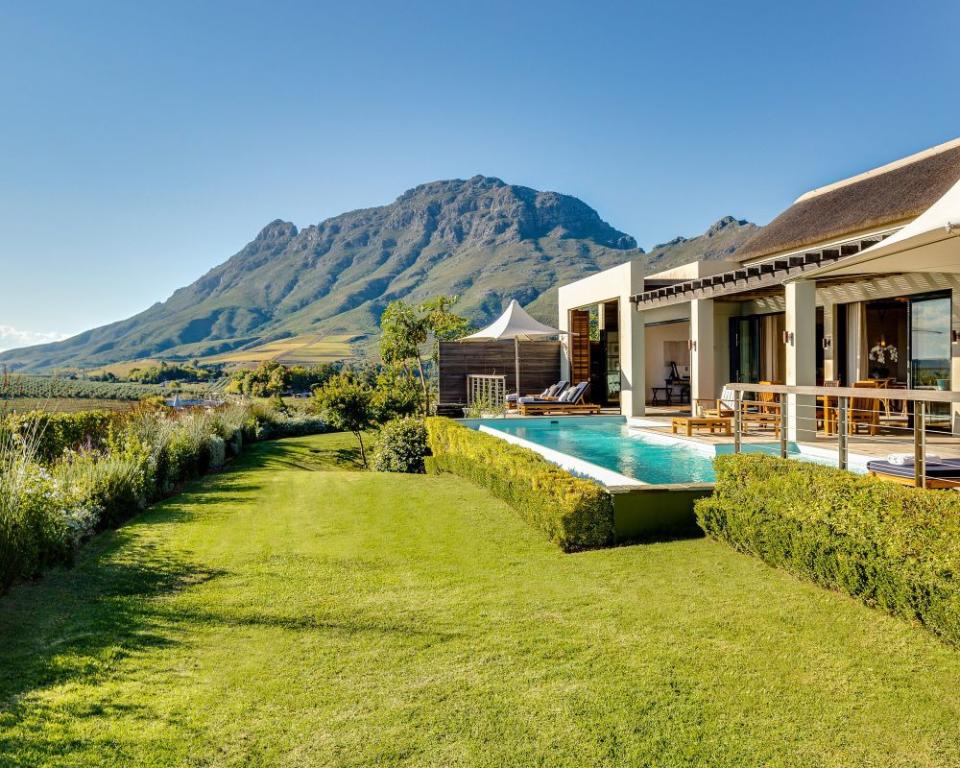 <p>Courtesy of Delaire Graff Lodges & Spa</p><p>Inspired by the landscape, culture and natural beauty of its Cape Winelands setting, Delaire Graff Estate is a destination devoted to beauty in its many forms. Created by renowned diamantaire Laurence Graff OBE, experience flawless hospitality, cuisine, wine, art and spa – and embrace the peace and serenity of your breathtaking surroundings.</p><p>Experience the pinnacle of Cape Winelands hospitality. Positioned atop the Helshoogte Pass, delight in the unforgettable setting, panoramic views and exceptional facilities. Ranked one of the most prestigious wineries in the world. At Delaire Graff we capitalise on the long, slow ripening season and unique terroir to produce an award-winning portfolio of wines.</p><p>Inside and out, the Estate serves as a gallery for an extraordinary art collection. Handpicked by Laurence Graff from his private collection, over 400 pieces of art and sculpture await discovery on the Estate.</p><p>“<em>Delaire Graff Estate is a place of exquisite natural beauty. We look forward to welcoming you</em>.” –Laurence Graff, Proprietor</p><p><a href="https://www.delaire.co.za/" rel="nofollow noopener" target="_blank" data-ylk="slk:Click here to make a reservation;elm:context_link;itc:0;sec:content-canvas" class="link ">Click here to make a reservation</a> </p>