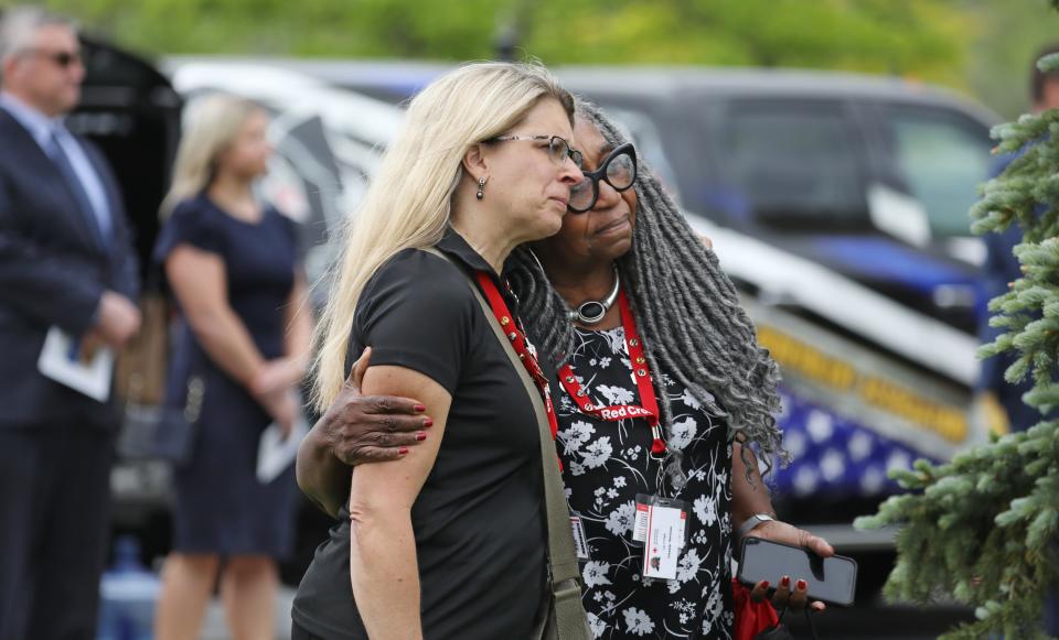 Friends, and family members watch as the casket of Aaron W. Salter Jr. leaves the Chapel at Cross Point Wednesday, May 25, 2022 in Getzville following his funeral service.  Salter was killed during a mass shooting at a Buffalo area Tops grocery a week ago. 