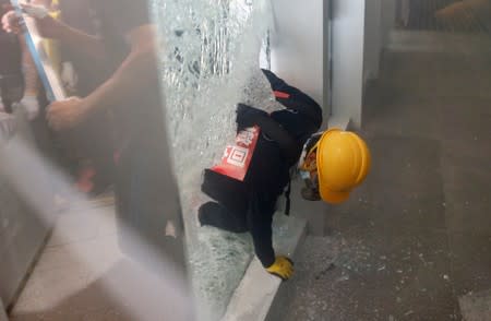 Protester breaks into the Legislative Council building during the anniversary of Hong Kong's handover to China in Hong Kong