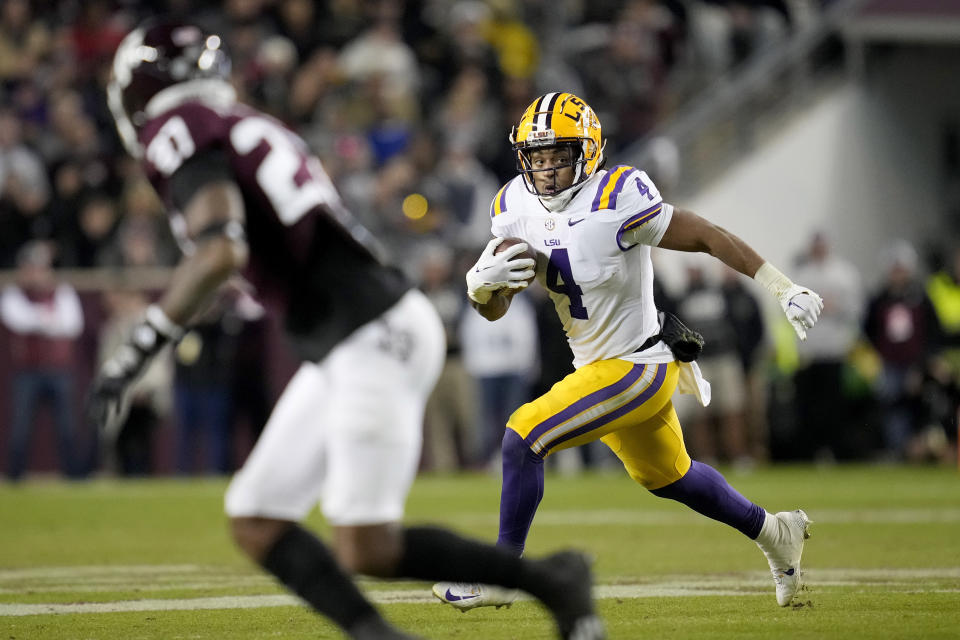 LSU running back John Emery Jr. (4) carries as Texas A&M defensive back Antonio Johnson (27) defends during the second quarter of an NCAA college football game Saturday, Nov. 26, 2022, in College Station, Texas. (AP Photo/Sam Craft)