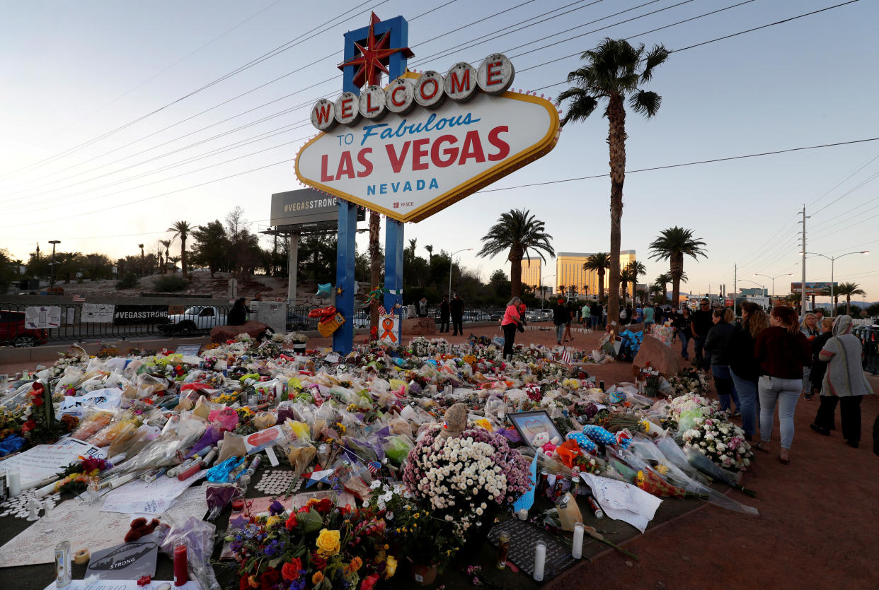 A makeshift memorial of flowers, candles and messages surrounds the "Welcome to Las Vegas" sign in the week after the Oct. 1 mass shooting. (Photo: Steve Marcus/Las Vegas Sun via Reuters)