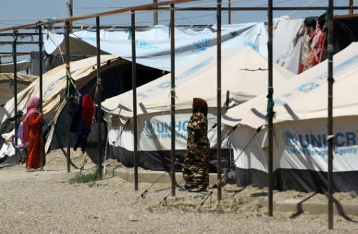 Displaced Iraqi women walk in "Camp Seven" near al-Khalidiyeh in Iraq's western Anbar province on April 24, 2018