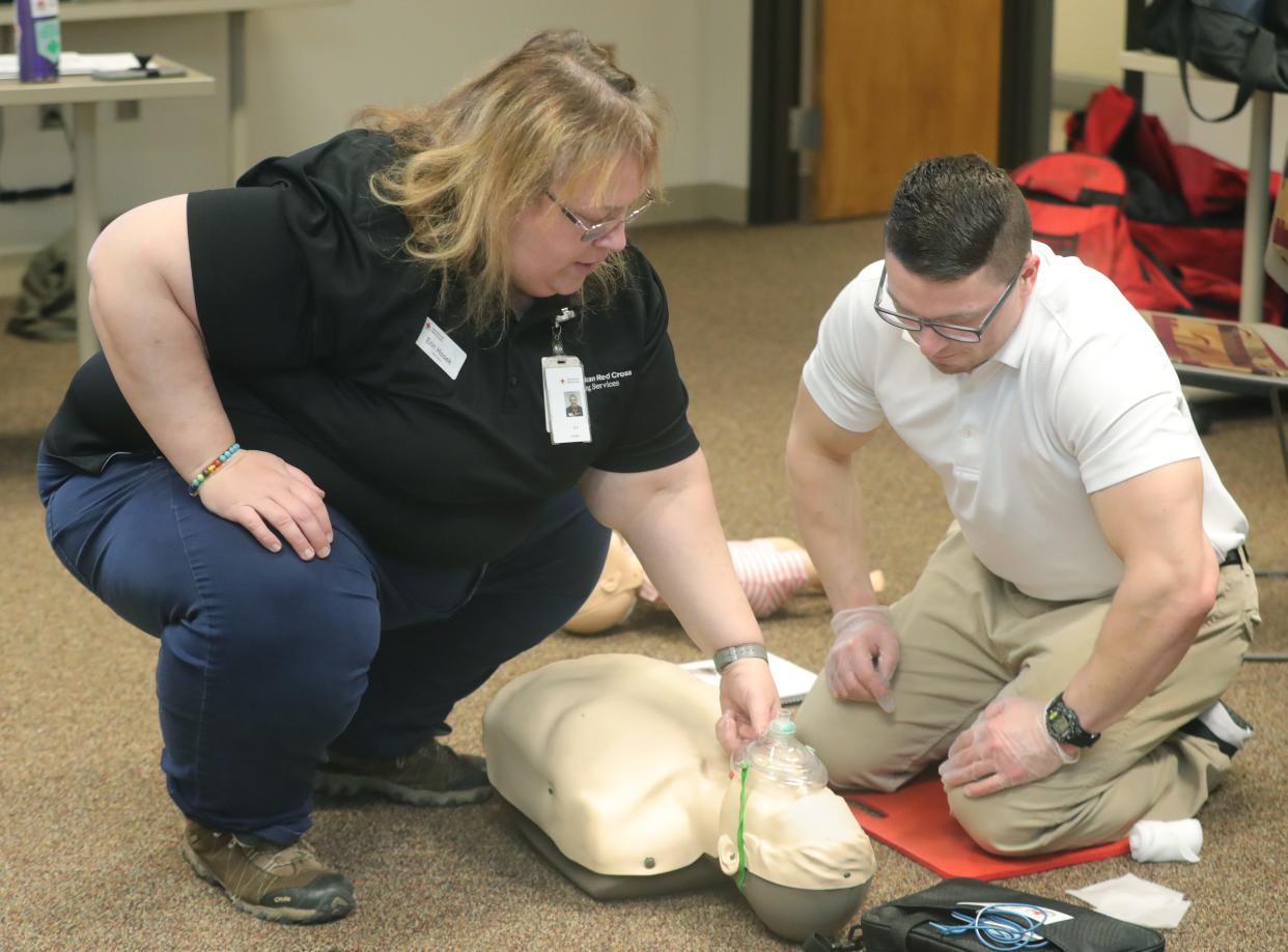 Summit County Red Cross instructor Erin Hosek works with Chris Troll of Broadview Heights during CPR class on Wednesday in Akron.