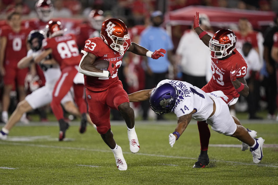 Houston running back Parker Jenkins (23) is tackled by TCU's Randon Fontenette (14) during the second half of an NCAA college football game Saturday, Sept. 16, 2023, in Houston. (AP Photo/David J. Phillip)