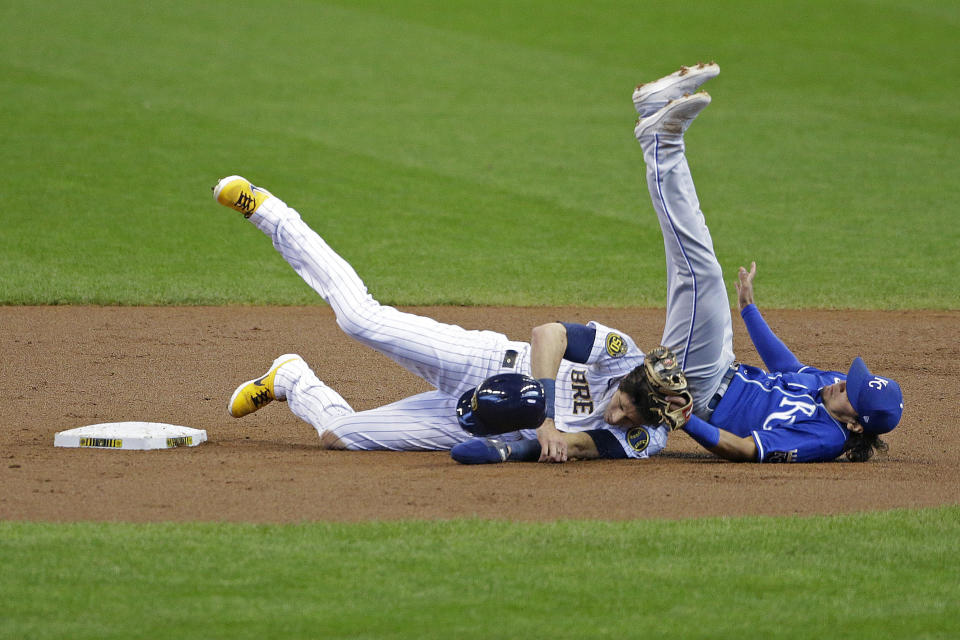 Milwaukee Brewers' Christian Yelich collides with Kansas City Royals' Nicky Lopez after being tagged out at second base during the first inning of a baseball game Sunday, Sept. 20, 2020, in Milwaukee. (AP Photo/Aaron Gash)